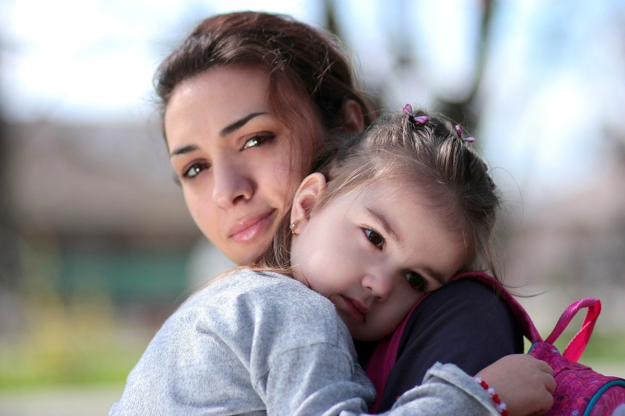 mother holding her daughter in types of parenting style