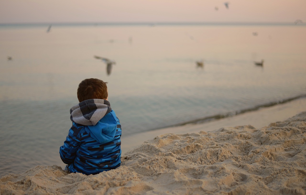 child alone watching in the sea